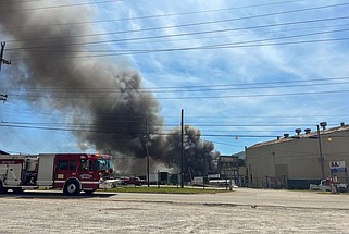 Staff photo by Olivia Ross / Clouds of smoke from a fire near 980 West 19th Street are seen on Tuesday. Piles of scrap metal burned at the recycling facility, according to the Chattanooga Fire Department.